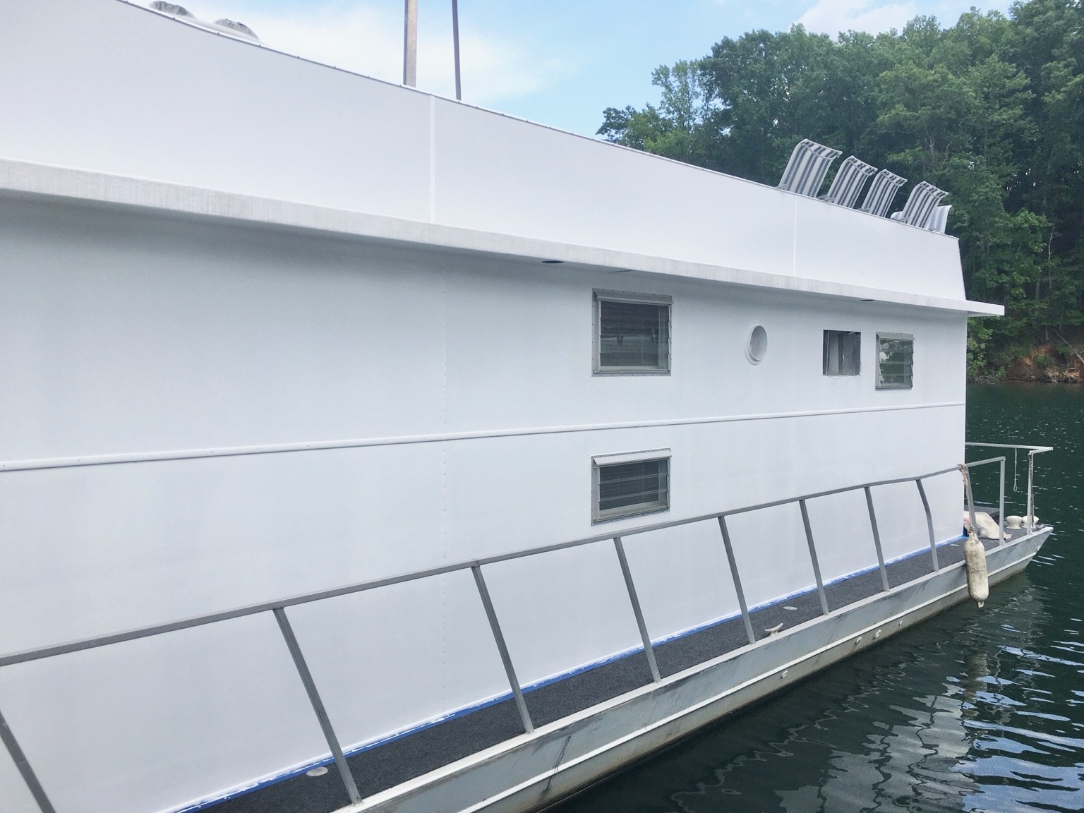 Finished houseboat exterior side view after marine renovation